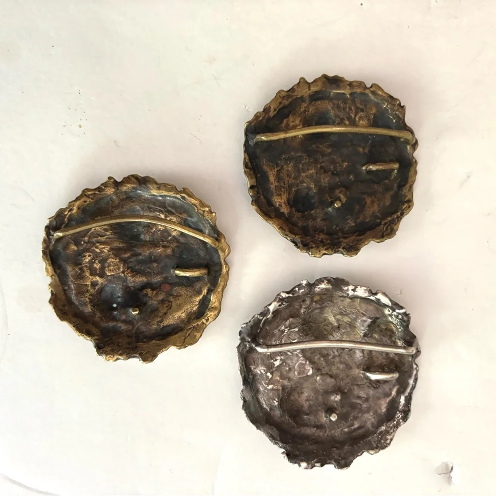 Three vintage belt buckles
